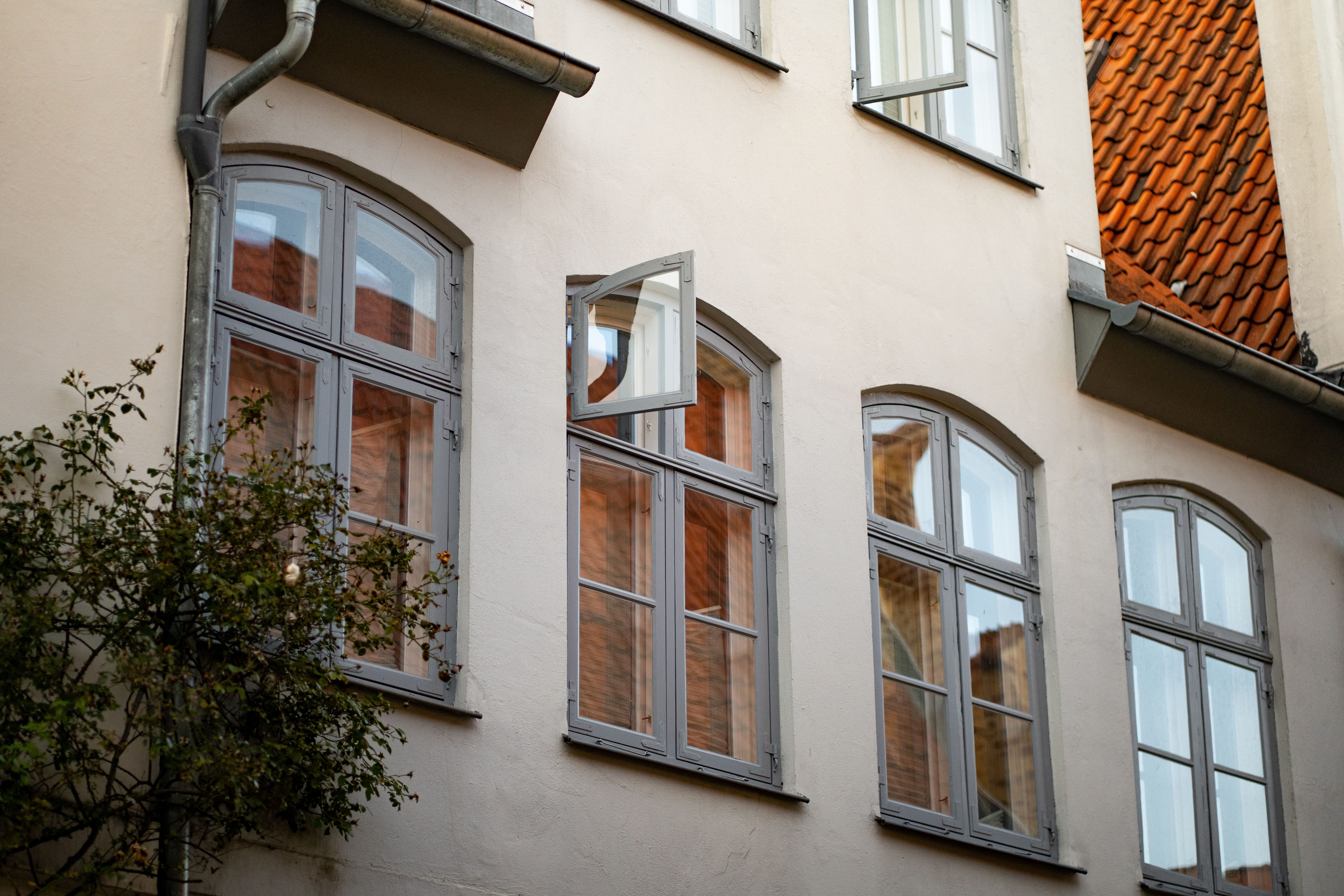 Old Building Facade with Open Windows · Free Stock Photo