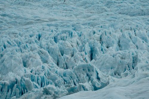 Free A close-up view of a glacier's rugged blue surface, showcasing its intricate textures. Stock Photo