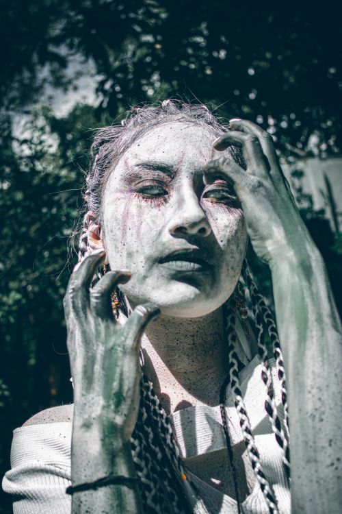 Free Surreal artistic portrait of a woman with ethereal makeup outdoors. Stock Photo