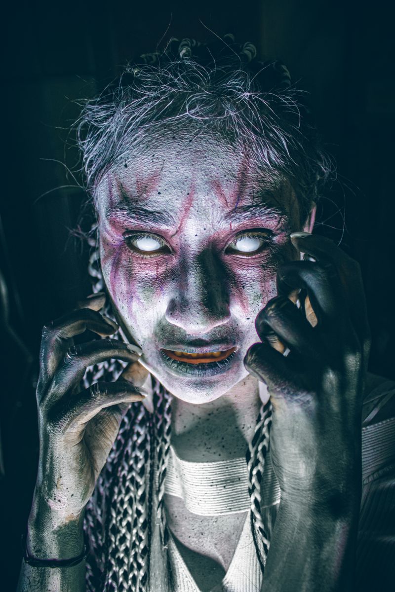 Eerie portrait with ghostly makeup creating a spooky, spiritual ambiance.