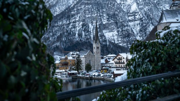 Stunning view of snowy Hallstatt, Austria, showcasing a serene lakeside village in winter.