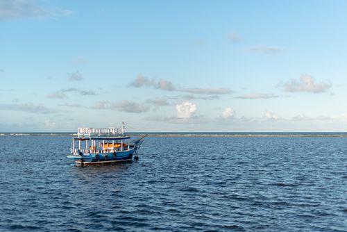 Free Experience tranquility with a lone boat on the Atlantic at Arraial d'Ajuda, Bahia, Brazil. Stock Photo