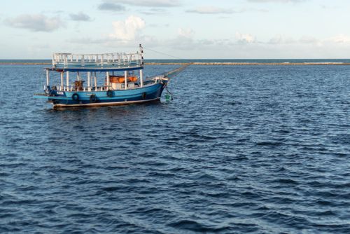 Free A tranquil scene of a blue boat on the ocean at Arraial d'Ajuda, Bahia, Brazil. Stock Photo