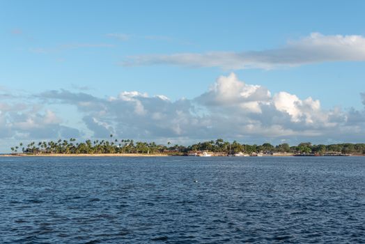 Discover the serene beauty of Arraial d'Ajuda's beachfront under a clear blue sky in Bahia, Brazil.