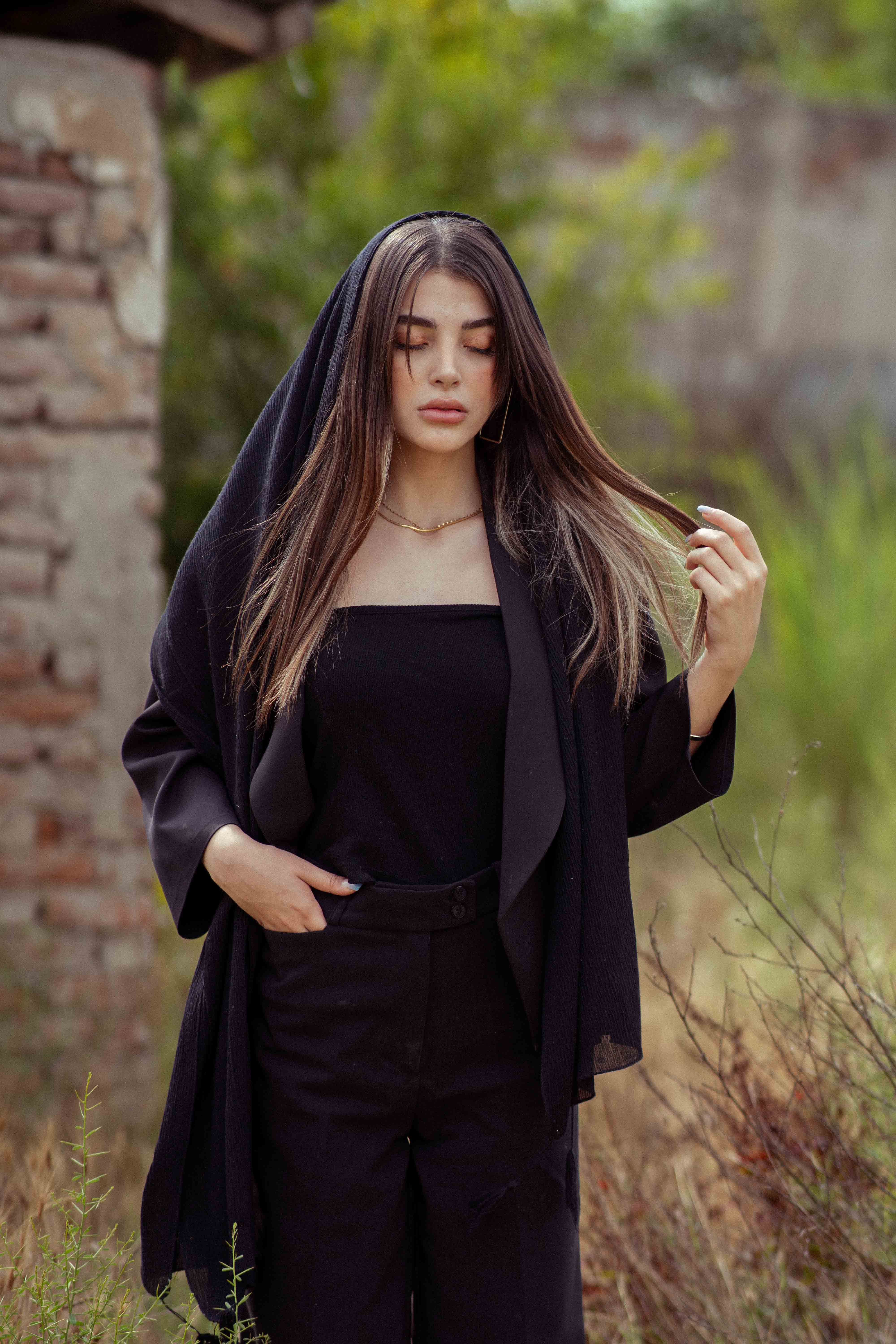 Beautiful young woman in traditional attire posing outdoors in Bandar Gaz, Iran.