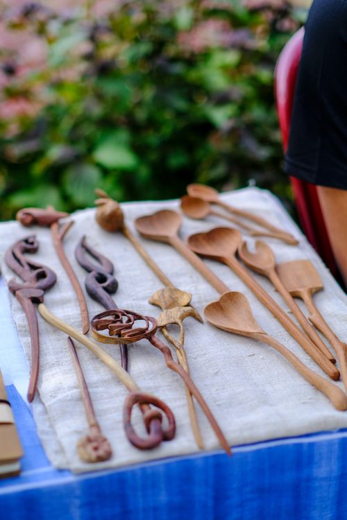 Free Artistic arrangement of handmade wooden utensils showcased in a vibrant outdoor market in Hue, Vietnam. Stock Photo