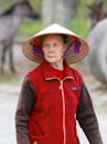 Elderly Woman in Traditional Vietnamese Hat Outdoors