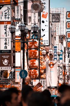 Bustling street in Osaka, Japan, filled with vibrant signs and bustling crowds, showcasing the city's lively atmosphere.
