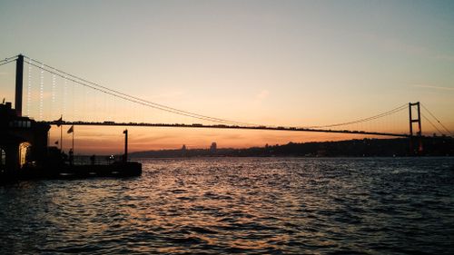 Free A stunning sunset view of the Bosphorus Bridge in Istanbul, Türkiye, capturing the serene evening atmosphere. Stock Photo