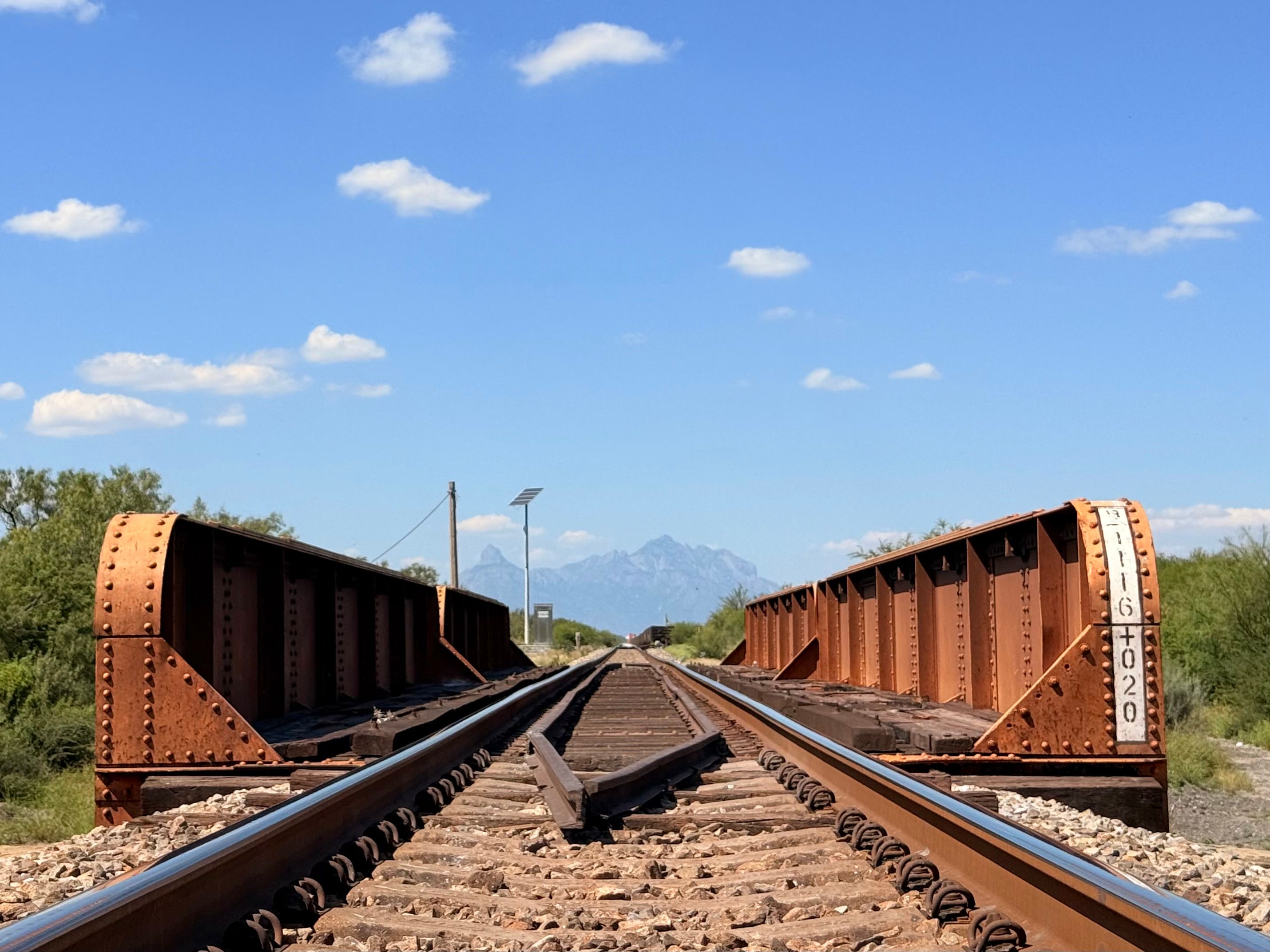 Rustic Railroad Tracks Leading into Scenic Landscape · Free Stock Photo