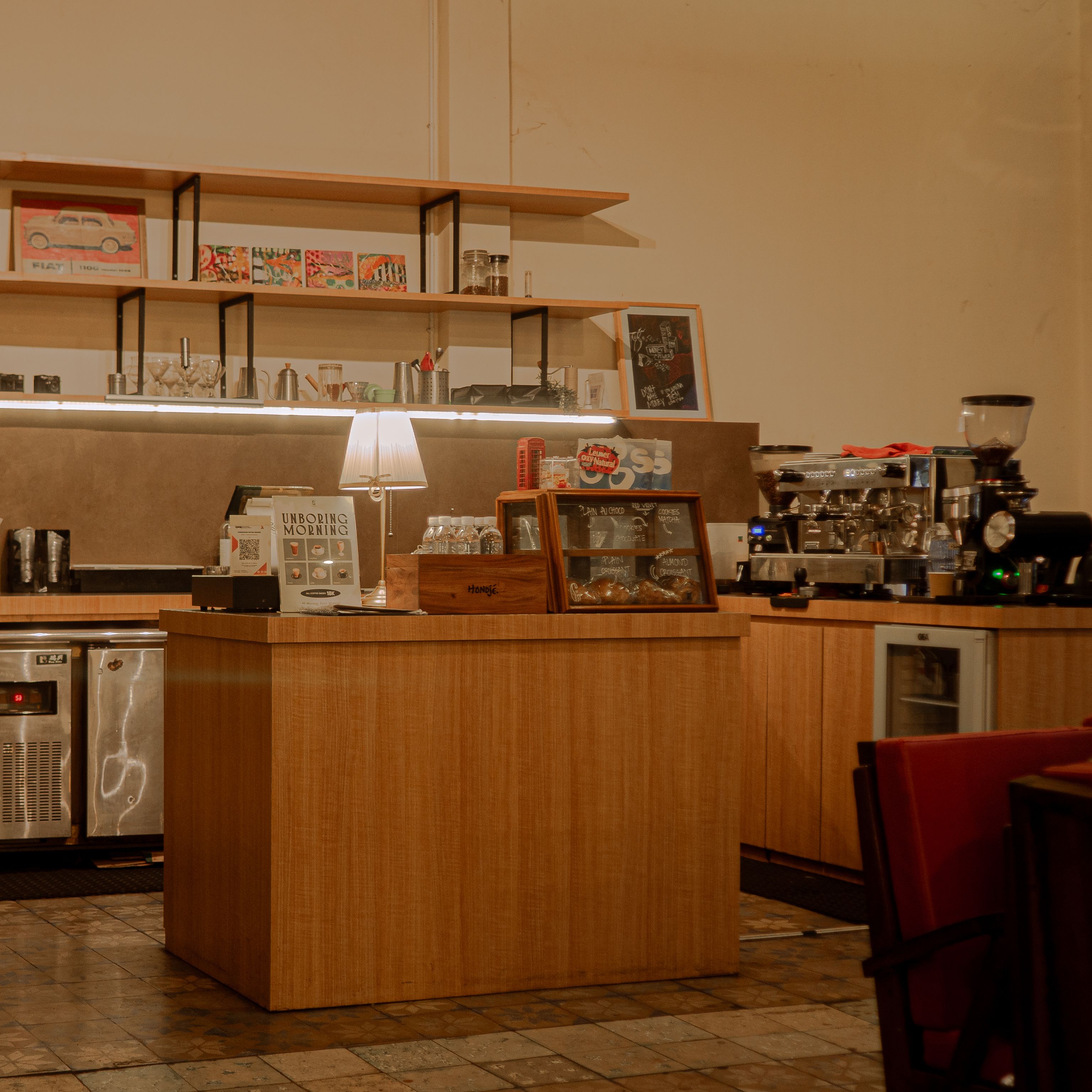 Inviting vintage coffee shop interior with rustic wood elements and soft, warm lighting.