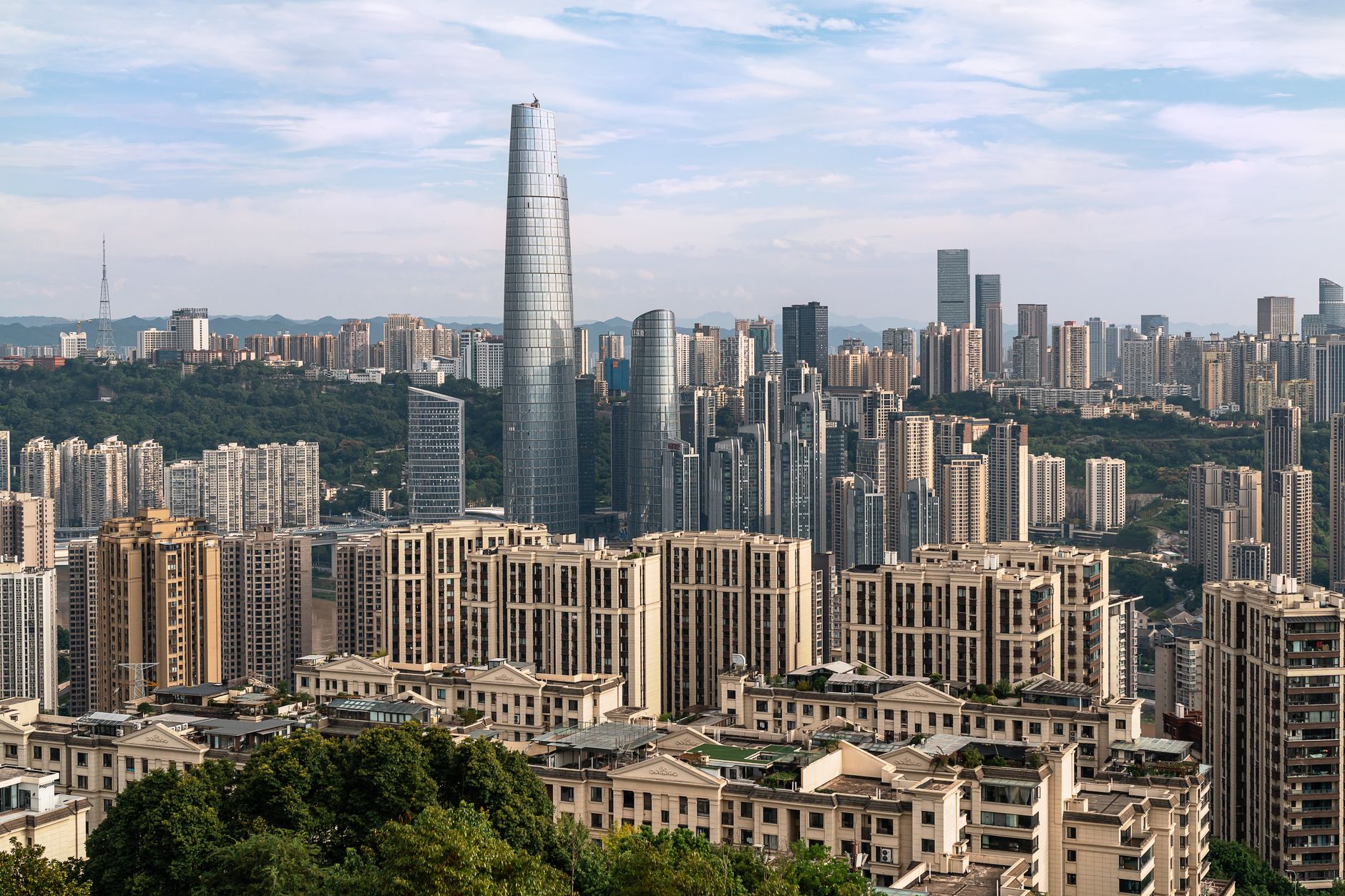 A dynamic cityscape showcasing tall skyscrapers under a clear sky, highlighting urban architecture.