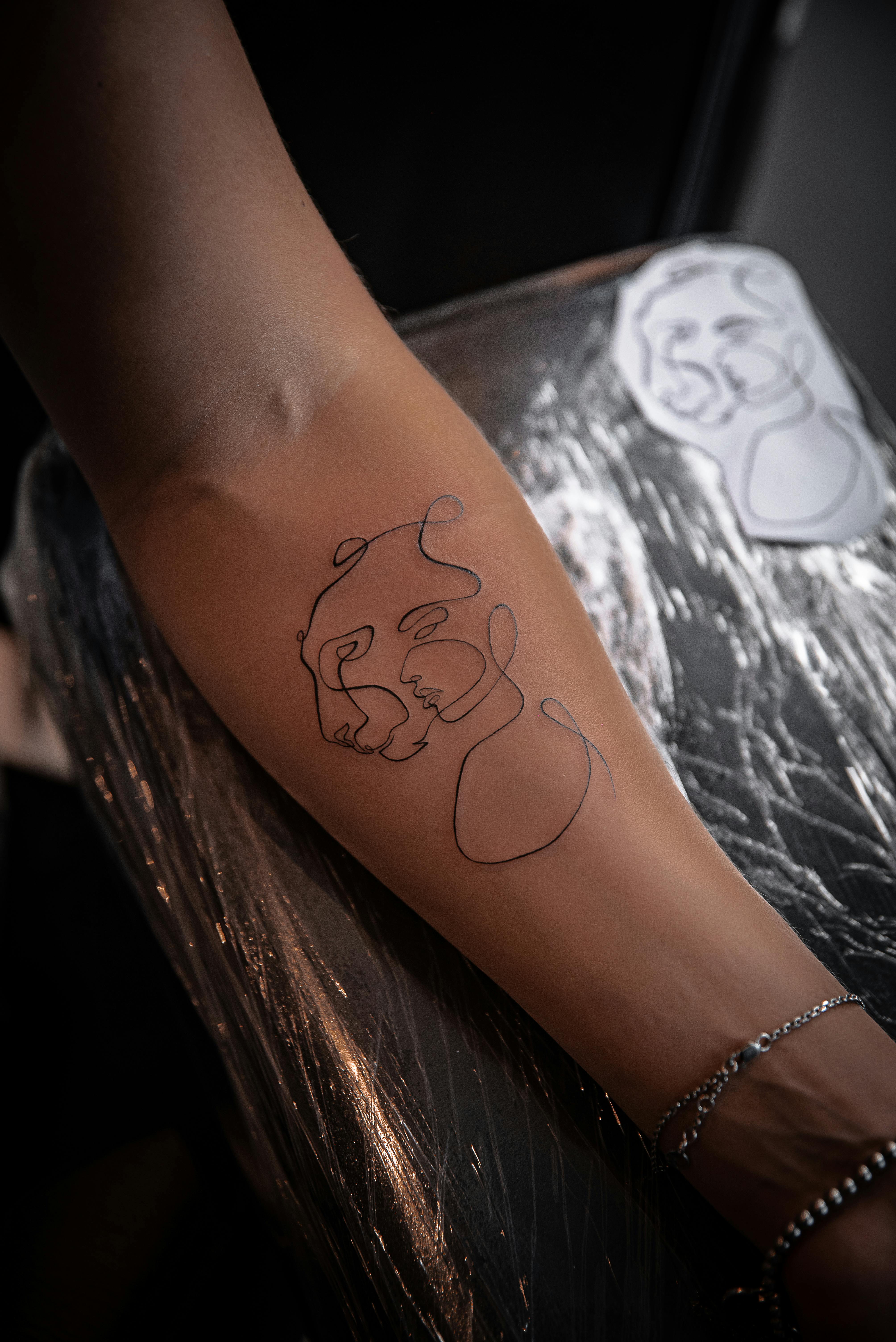 Minimalist fine line arm tattoo