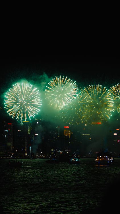 Vibrant Fireworks Over City Skyline at Night · Free Stock Photo