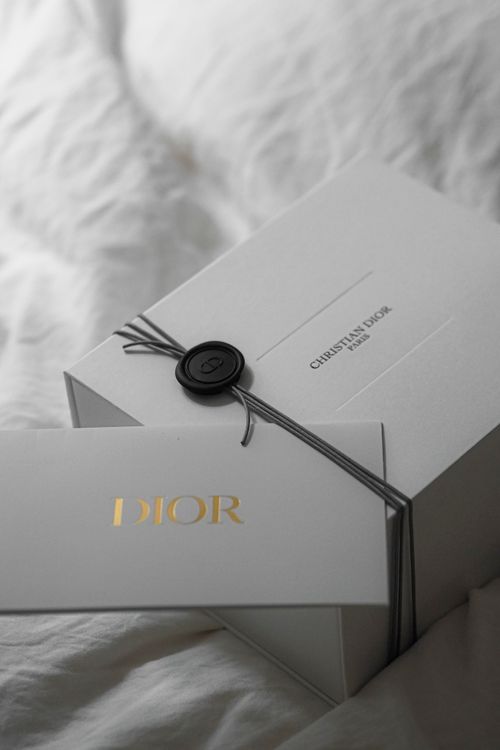 Free Sophisticated Dior packaging in luxurious Paris setting, perfect for fashion enthusiasts. Stock Photo