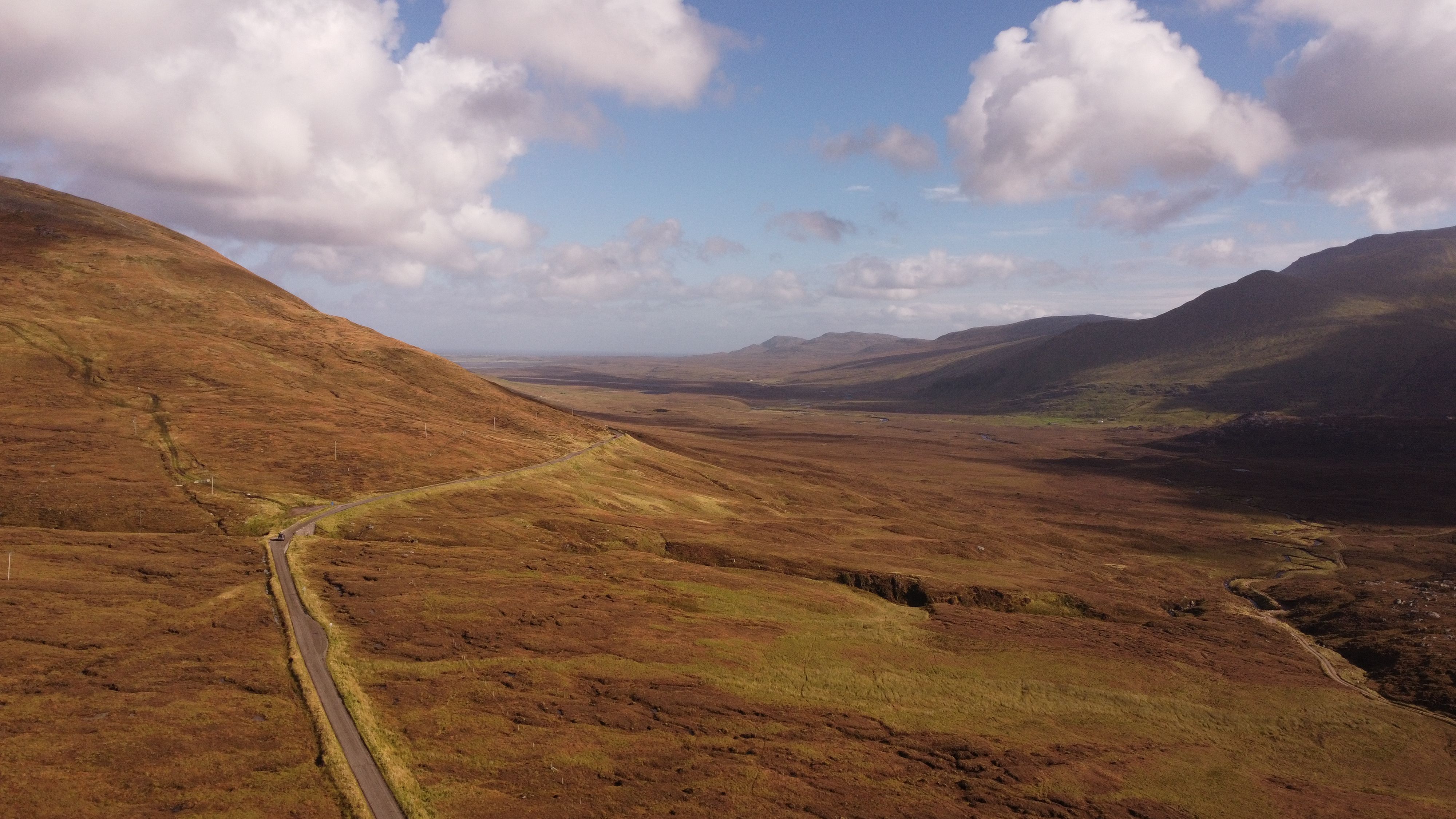 Breathtaking aerial view of the rolling hills and open skies in Lairg, Scotland.