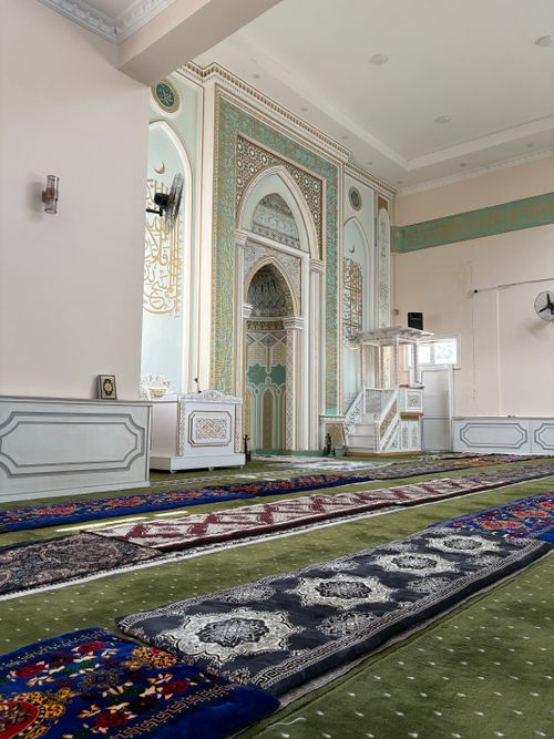 Free Beautiful mosque interior with ornate decorations and prayer rugs. Peaceful and serene setting. Stock Photo