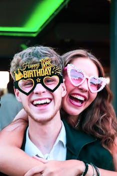 Two friends celebrating an 18th birthday with joyful expressions and festive attire.