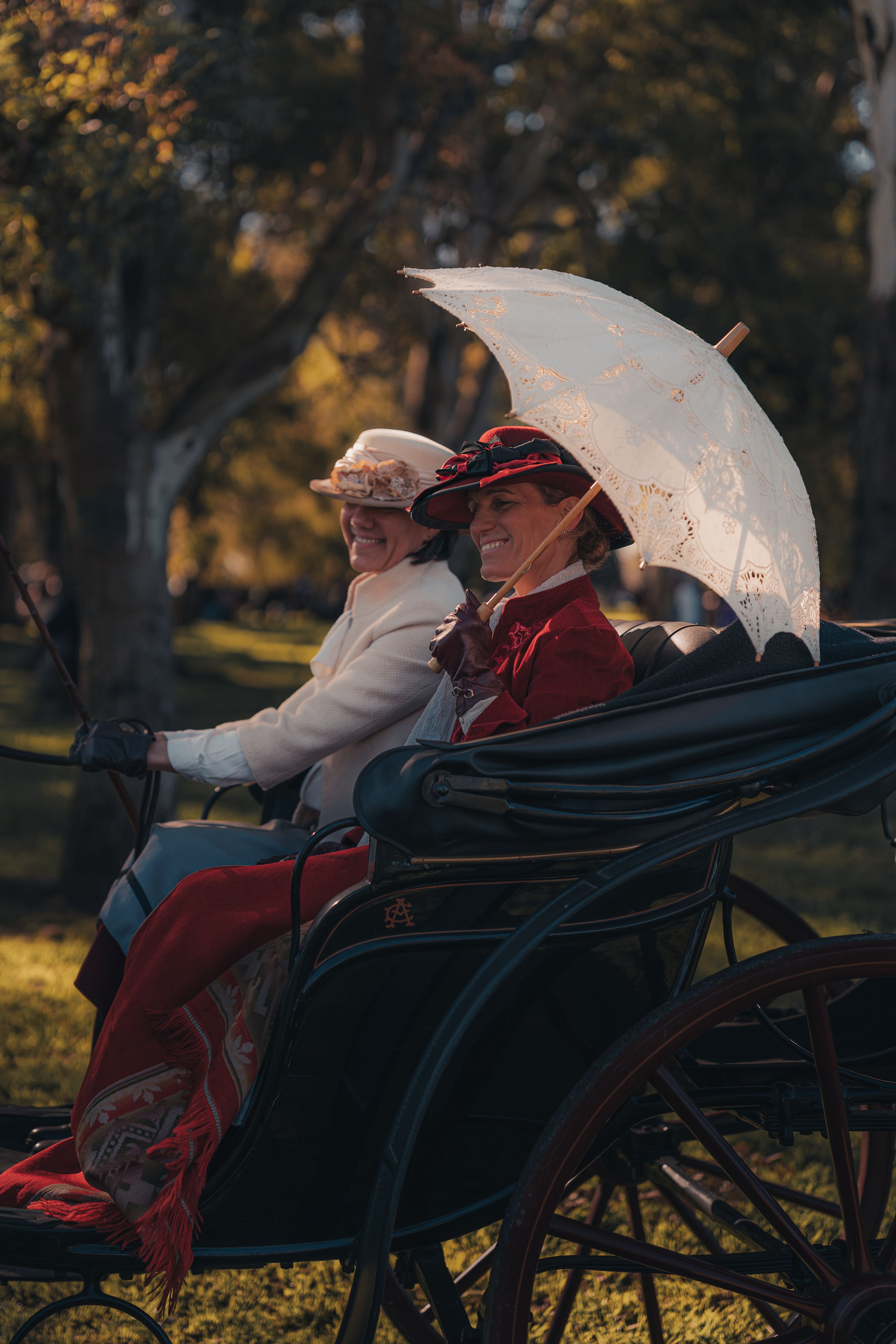 Victorian-Era Carriage Ride in a Scenic Park · Free Stock Photo