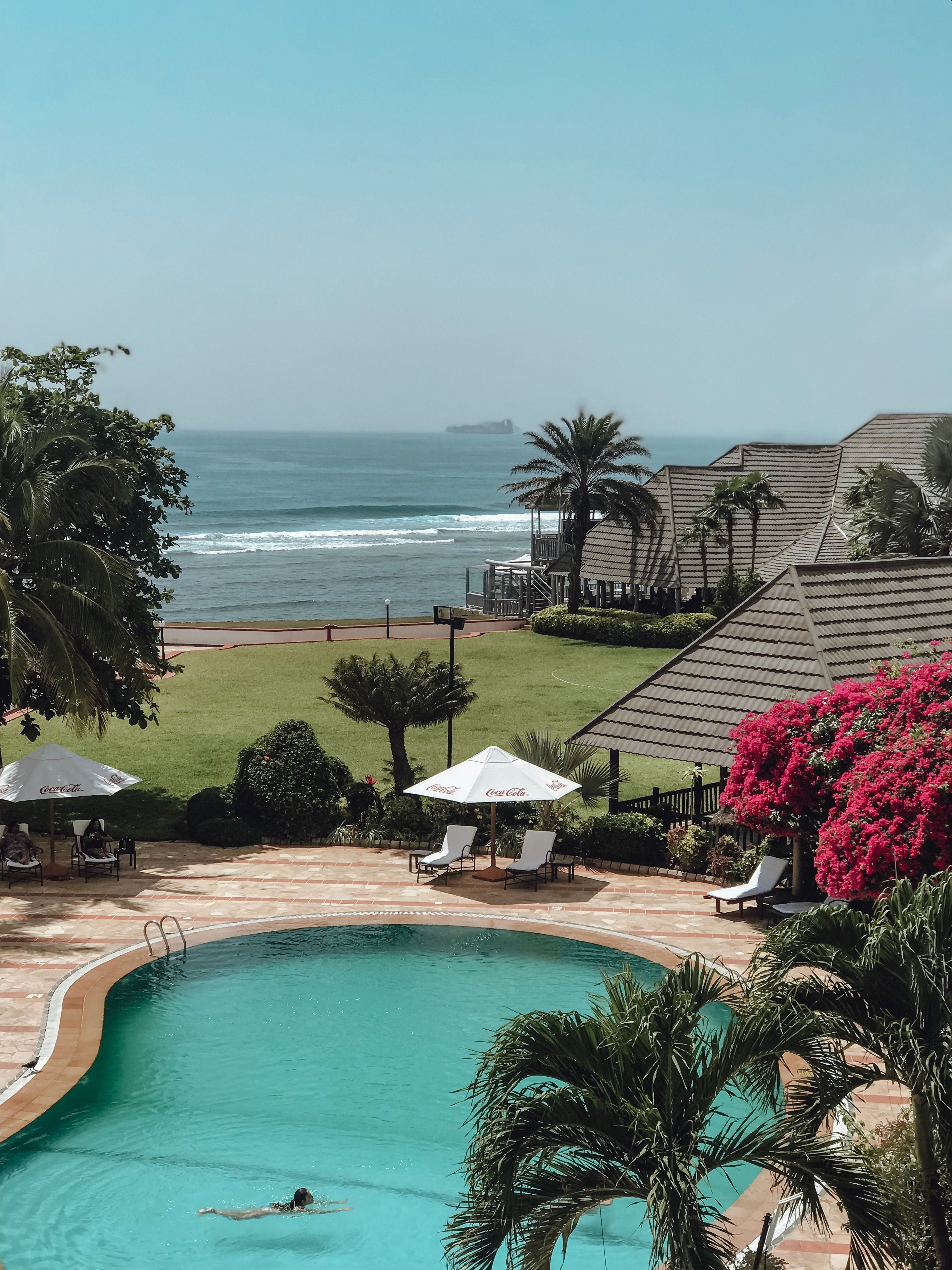 Beachfront pool and loungers at a 5-star family resort on the calm sands of Nusa Dua Bali
