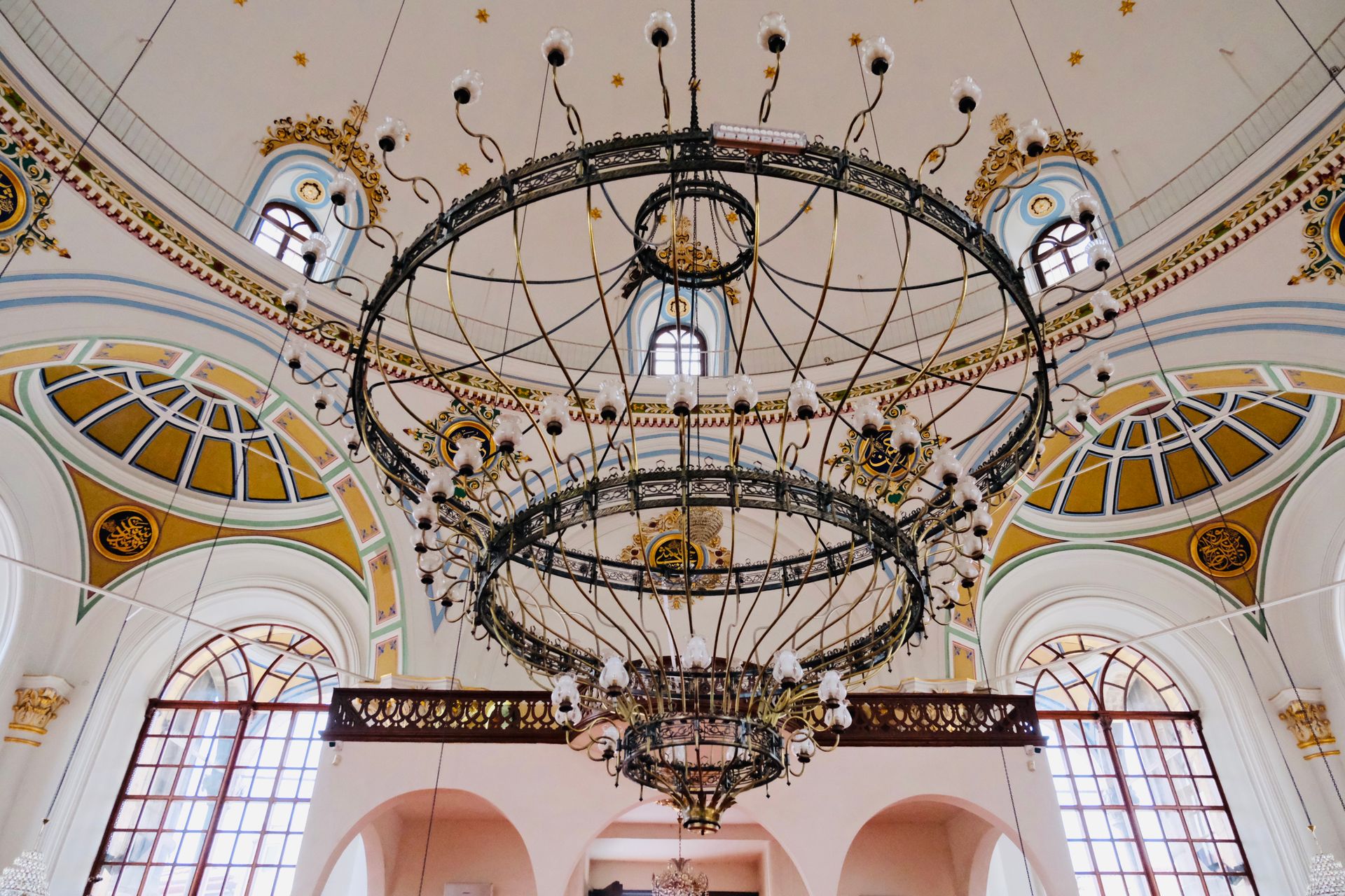 Stunning interior ceiling view with large ornate chandelier and elegant architectural details.