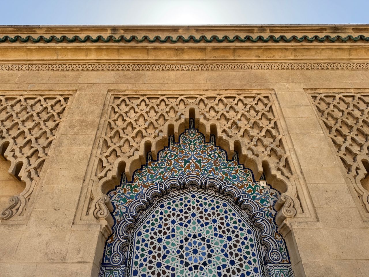 intricate moroccan tilework and stone carving in a traditional archite