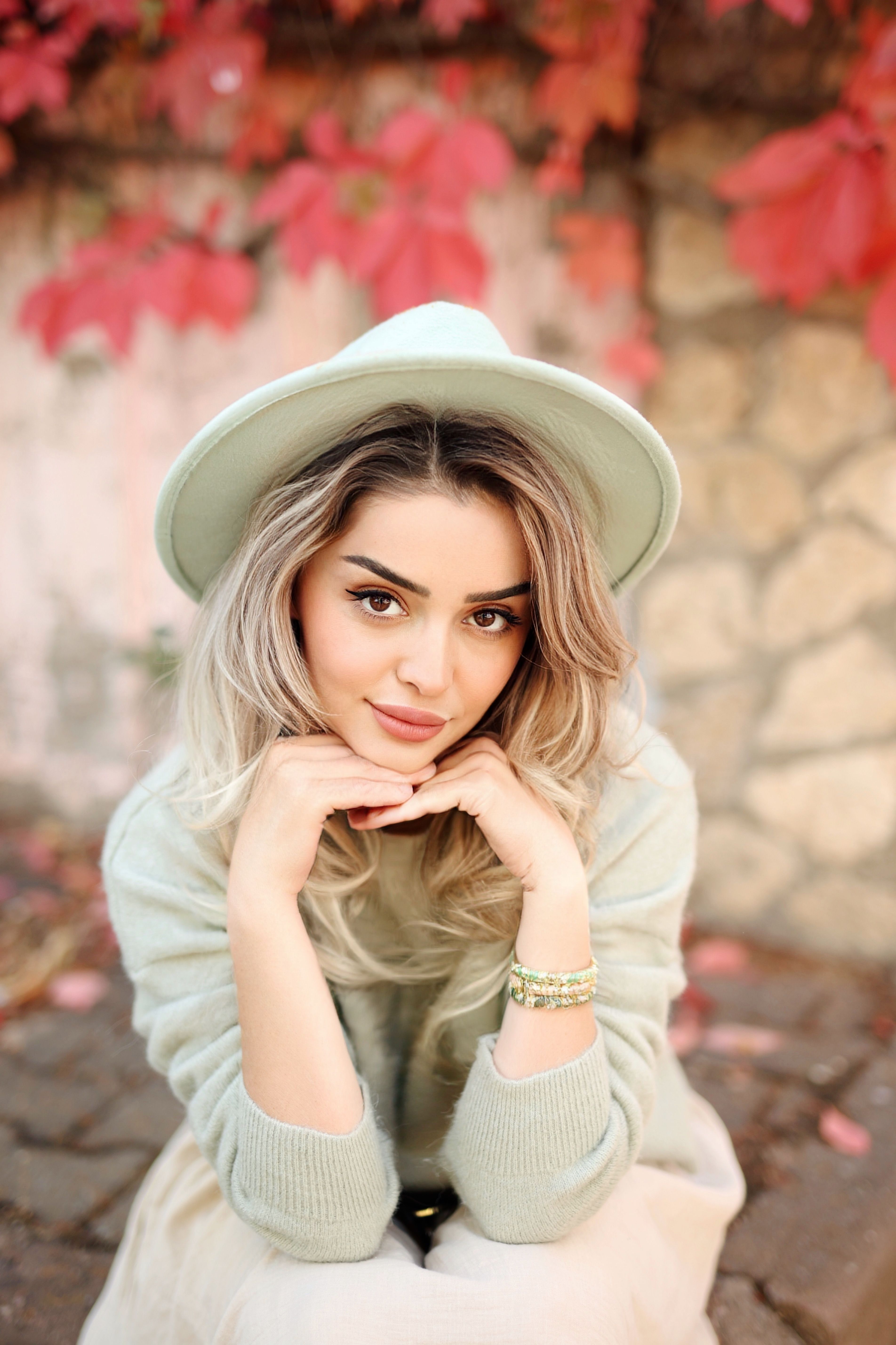Stylish Woman Posing with Autumn Leaves Backdrop · Free Stock Photo