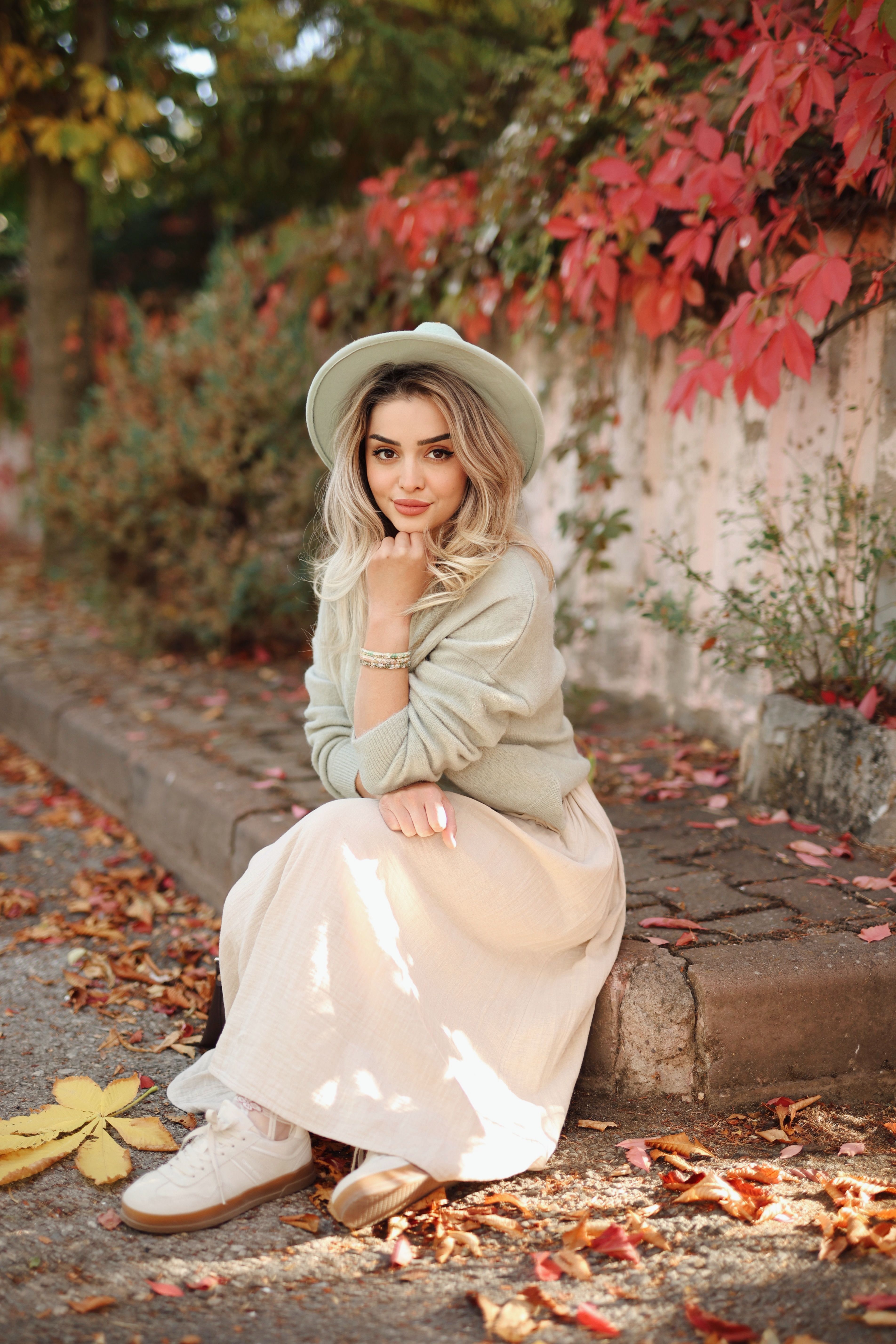 Stylish Woman Posing with Autumn Foliage · Free Stock Photo