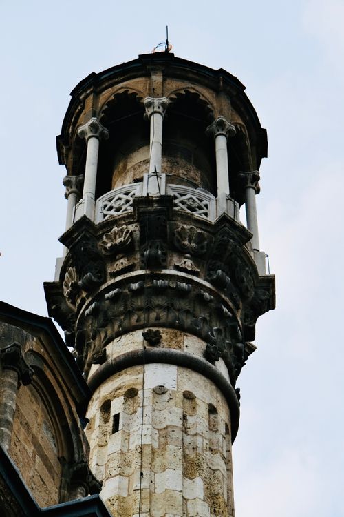 Free Close-up of a historic minaret showcasing detailed stone carvings and columns. Stock Photo