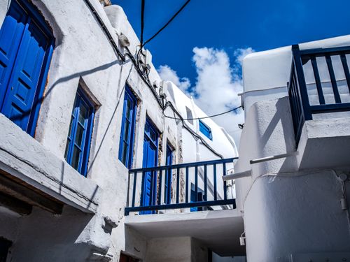 Free Traditional white buildings with blue accents in Mykonos, Greece, under a clear sky. Stock Photo