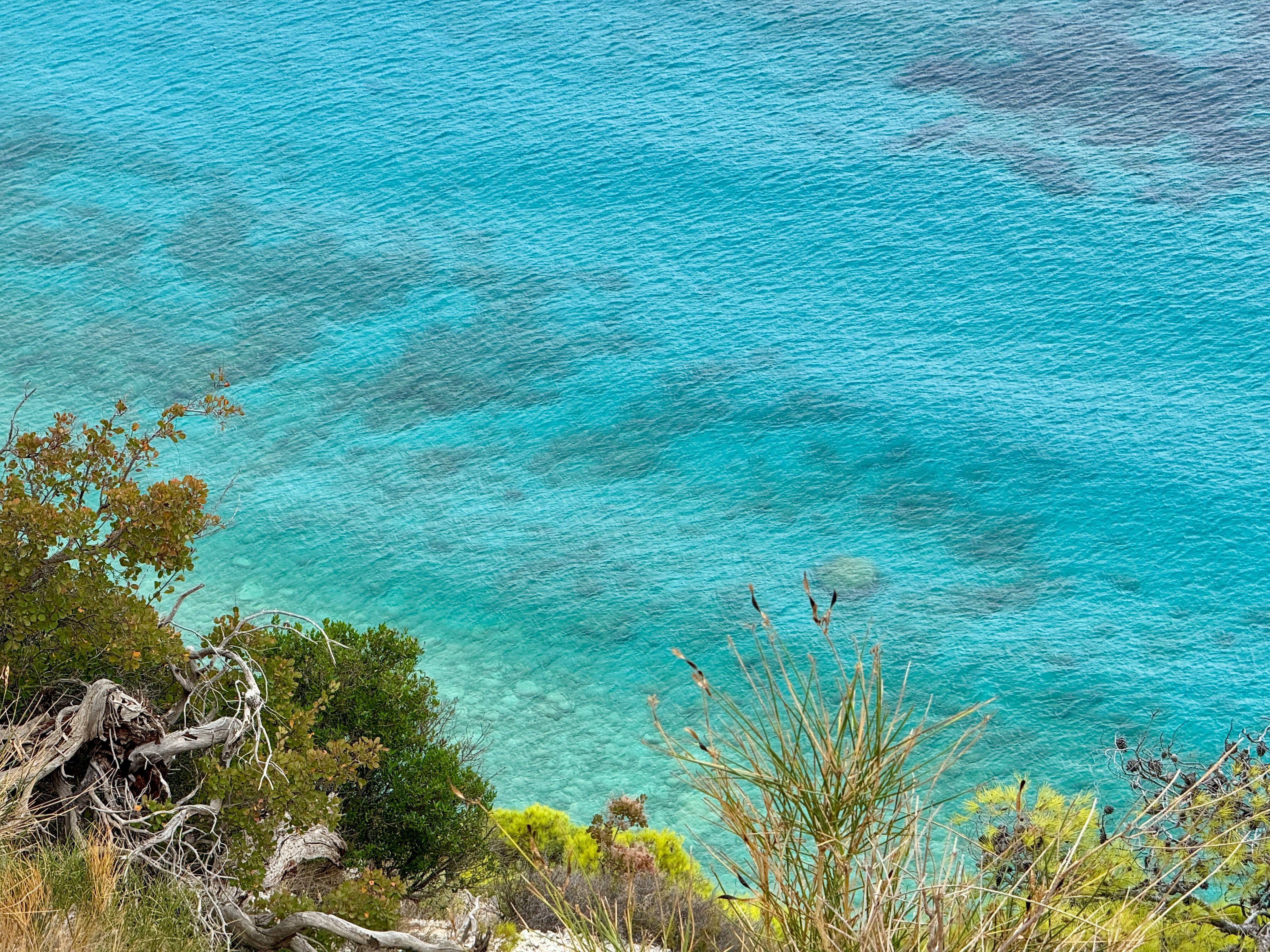 Stunning aerial view of the turquoise waters off the coast of Greece, showcasing natural beauty and tranquility. - Photo by Bejerita Marius on Pexels