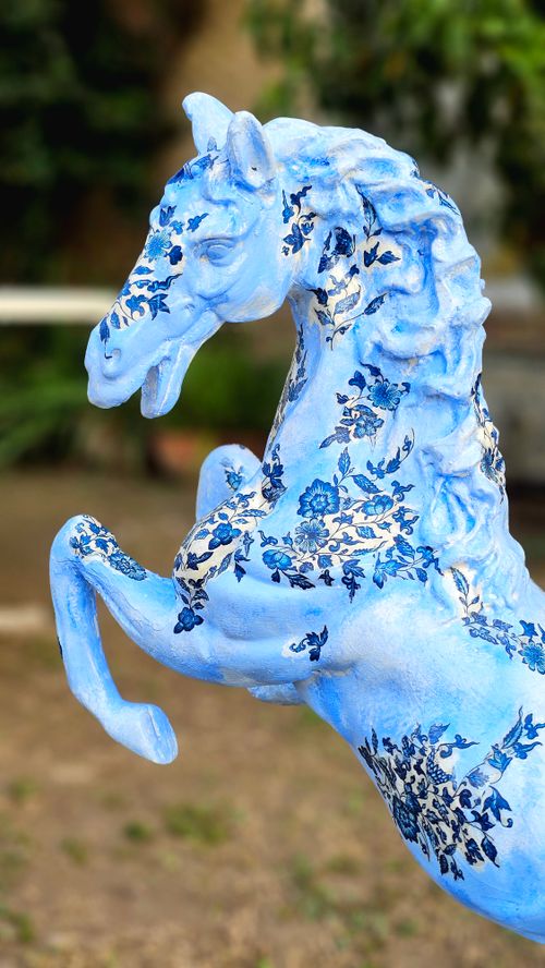 Free Vibrant blue horse sculpture featuring intricate floral designs outdoors. Stock Photo