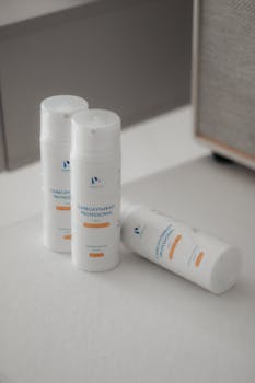 Minimalist display of three skincare bottles indoors, soft lighting.