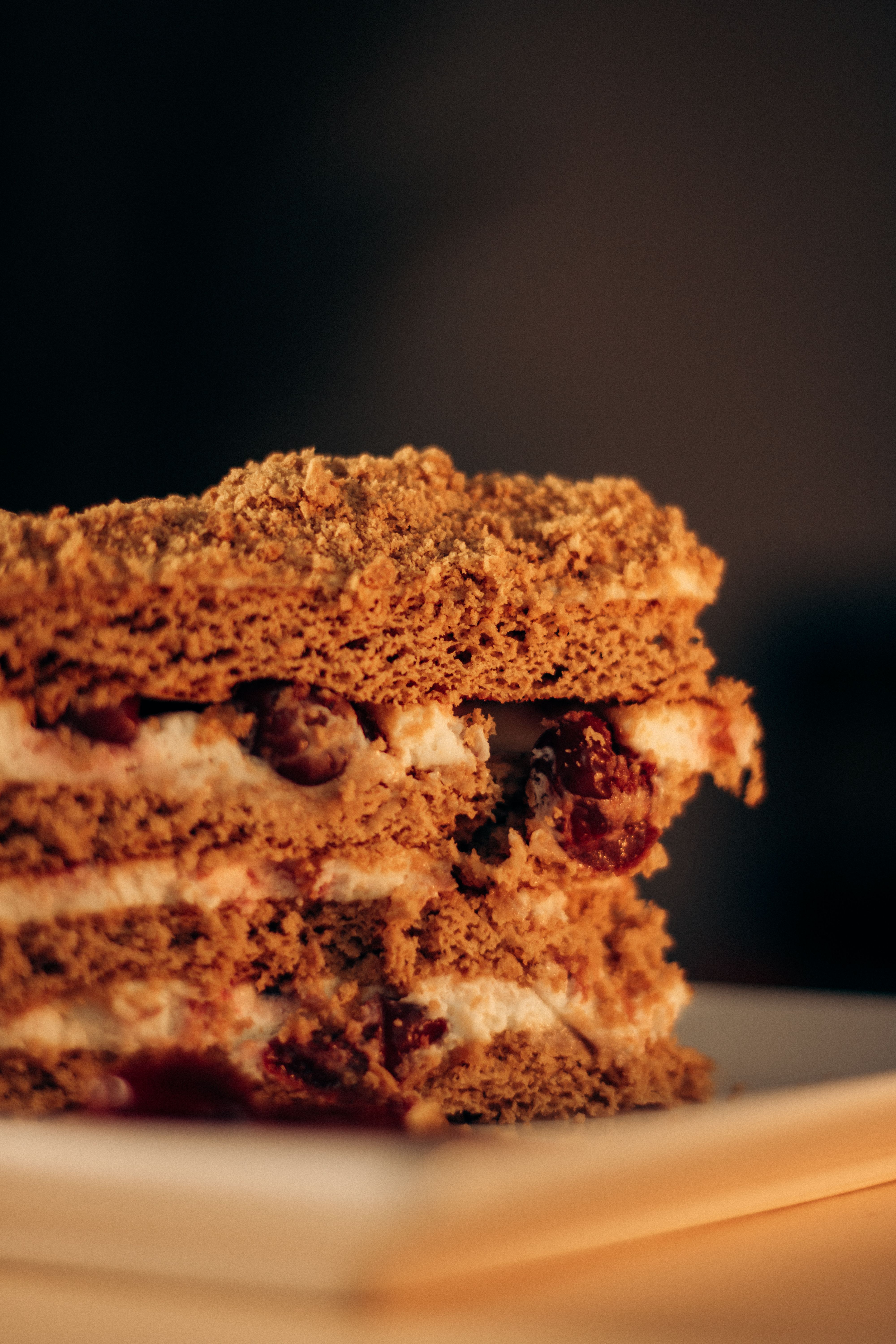 A tempting slice of layered cake with cream and cherry filling, perfect for dessert lovers.