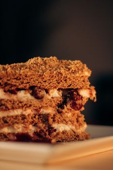 A tempting slice of layered cake with cream and cherry filling, perfect for dessert lovers.