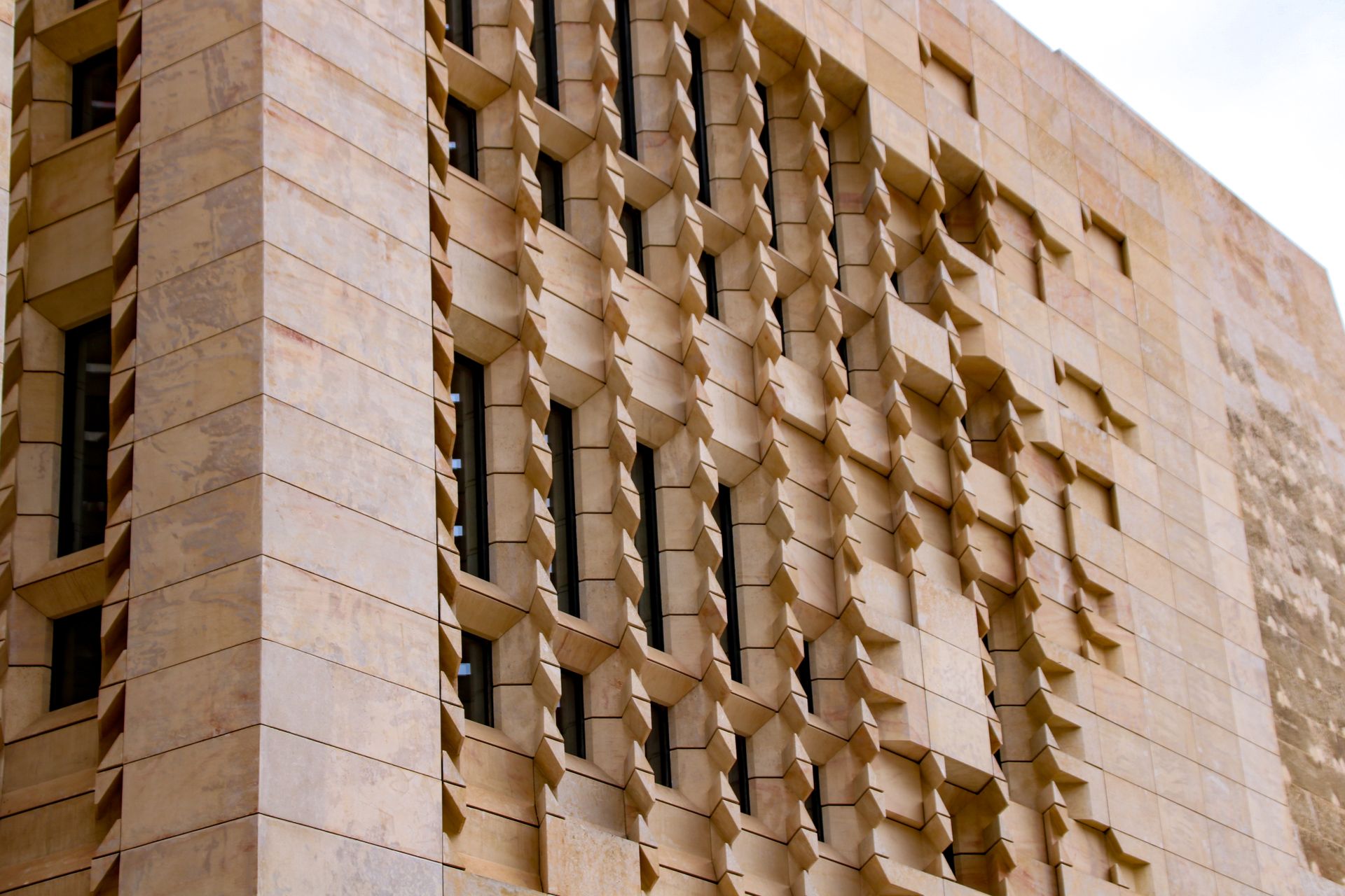 Close-up of a contemporary building facade in Valletta, showcasing unique architectural design.