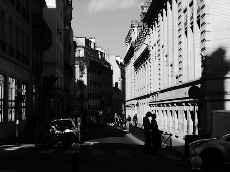 Charming black and white street scene showcasing Paris's architectural elegance.