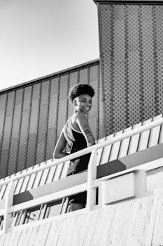 Elegant black and white portrait of a woman smiling outdoors in Berlin.