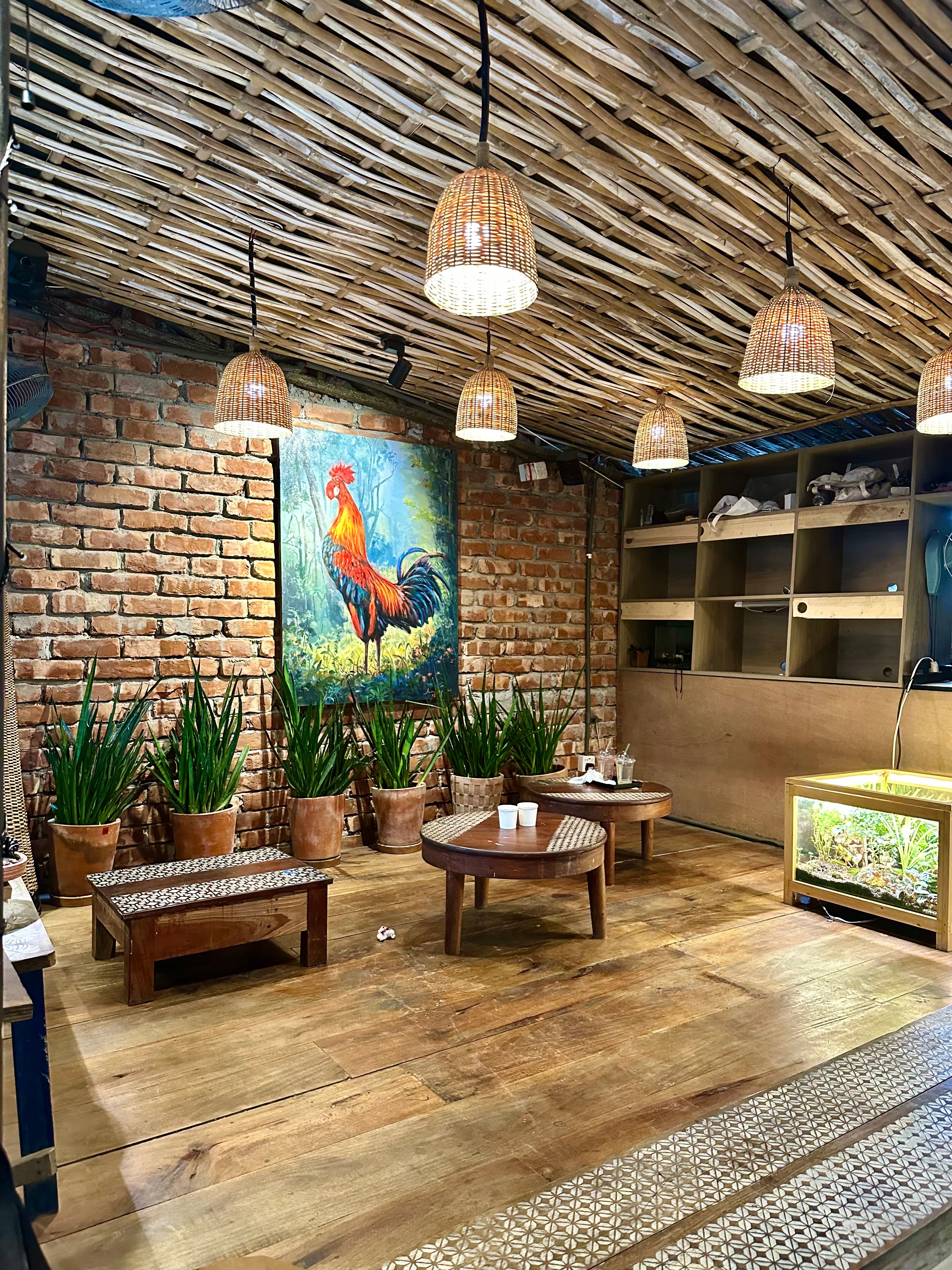 Cozy Rustic Café Interior with Plants and Artwork · Free Stock Photo