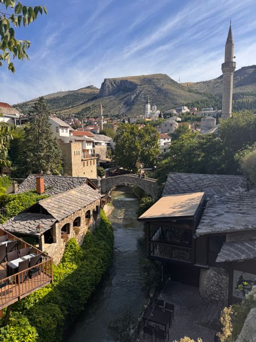 Free Picturesque cityscape of Mostar featuring a river and Ottoman architecture under a clear sky. Stock Photo