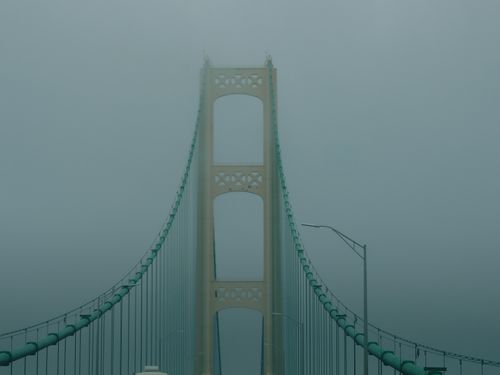 Free Mystical view of Mackinac Bridge disappearing into dense fog in Michigan. Stock Photo