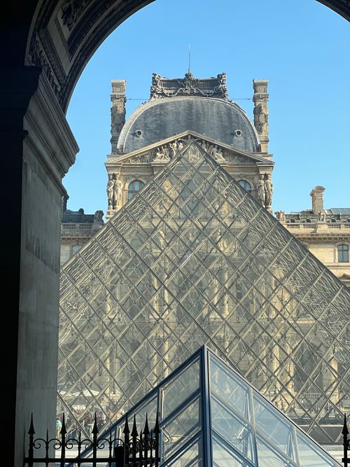 Free Iconic Louvre Pyramid against the historic museum backdrop in Paris. Stock Photo