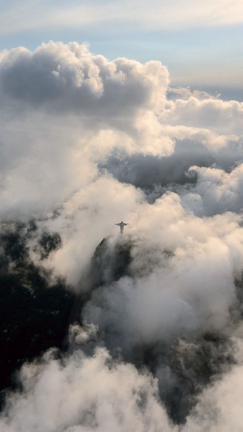 Free Stunning aerial view of Christ the Redeemer surrounded by clouds in Rio de Janeiro, Brazil. Stock Photo