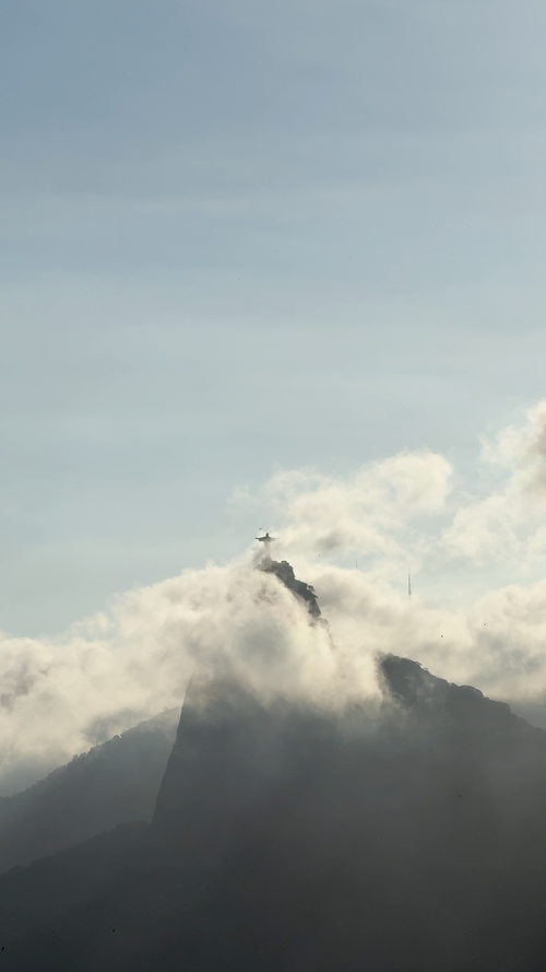 Free Stunning view of Christ the Redeemer statue emerging through clouds in Rio de Janeiro, Brazil. Stock Photo