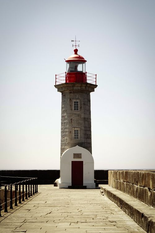 Free A stunning lighthouse stands tall under a clear sky, perfect for travel and architecture enthusiasts. Stock Photo