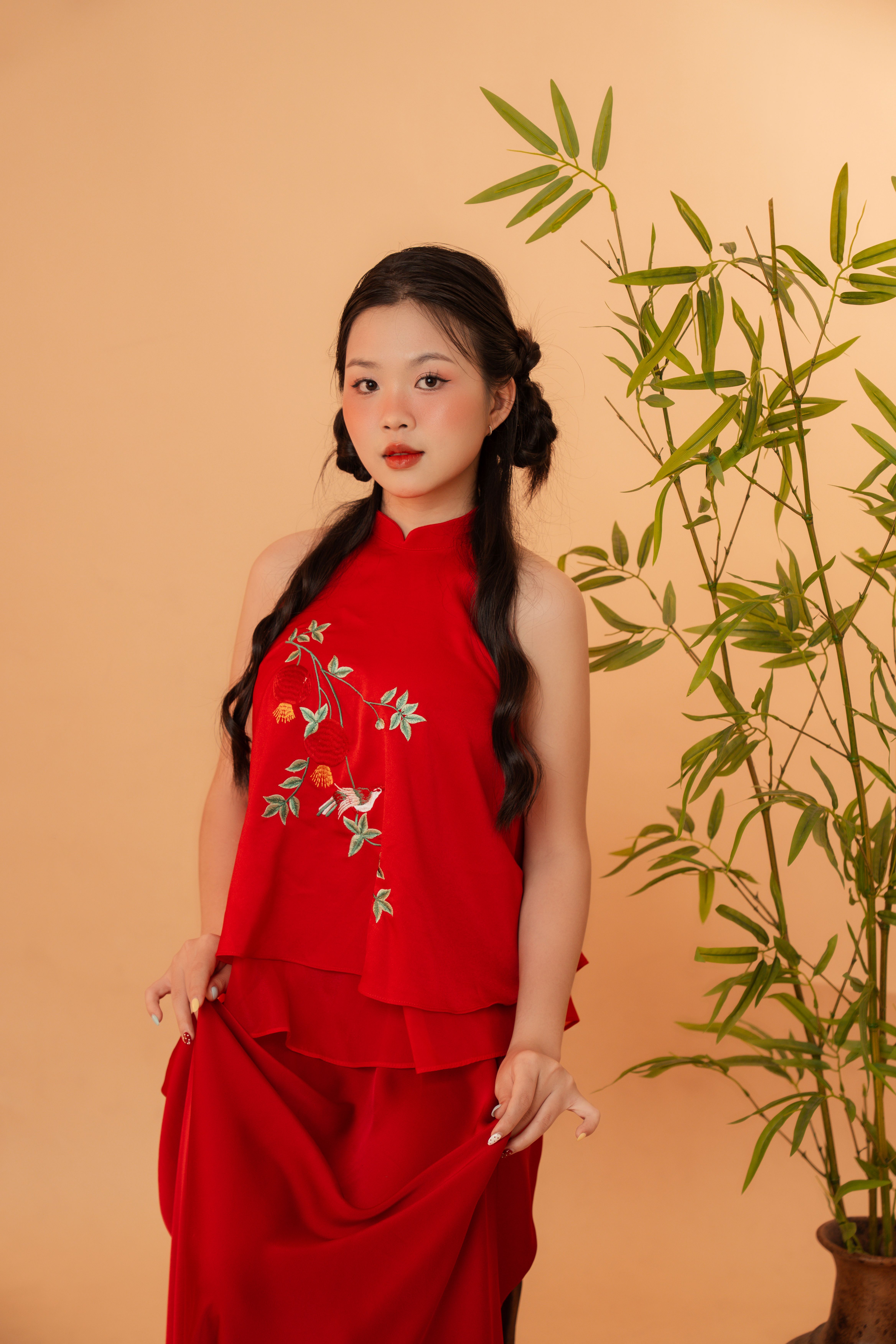 Elegant Woman in Red Dress Beside Bamboo · Free Stock Photo