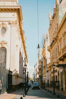 Charming historical street in Buenos Aires lined with ornate architecture under a clear blue sky.