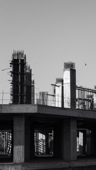 Monochrome image of a concrete construction site with vertical columns.