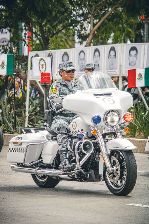 Free Military personnel on a motorcycle participates in a parade in Mexico City, showcasing national pride. Stock Photo