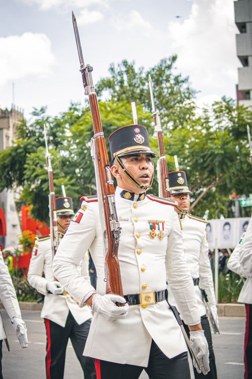 Free Soldiers march in ceremonial uniforms during a parade in Mexico City. Stock Photo
